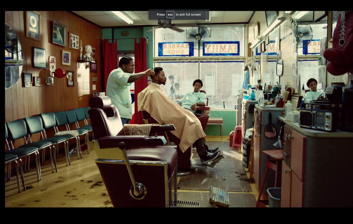 Classic barbershop interior with vintage chairs, warm wood paneling, and framed pictures