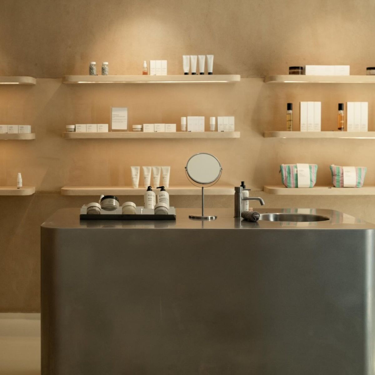 Studio Lilac luxury interior with warm lighting and premium skincare products on minimalist shelving
