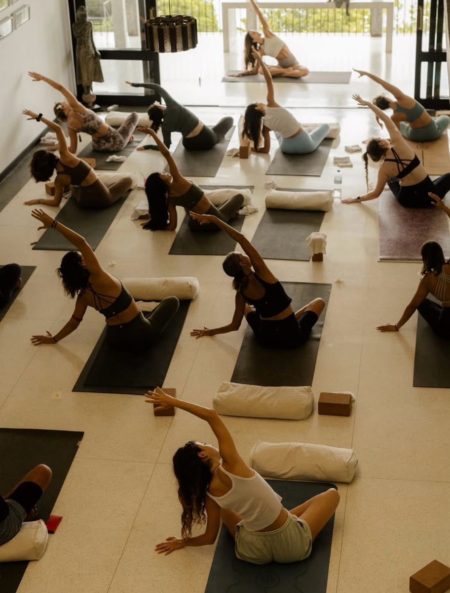 Group Pilates class in a bright studio with natural light